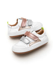 Angled view of baby Landy sneakers in white with rose gold and silver panels, featuring a wide toe box design.