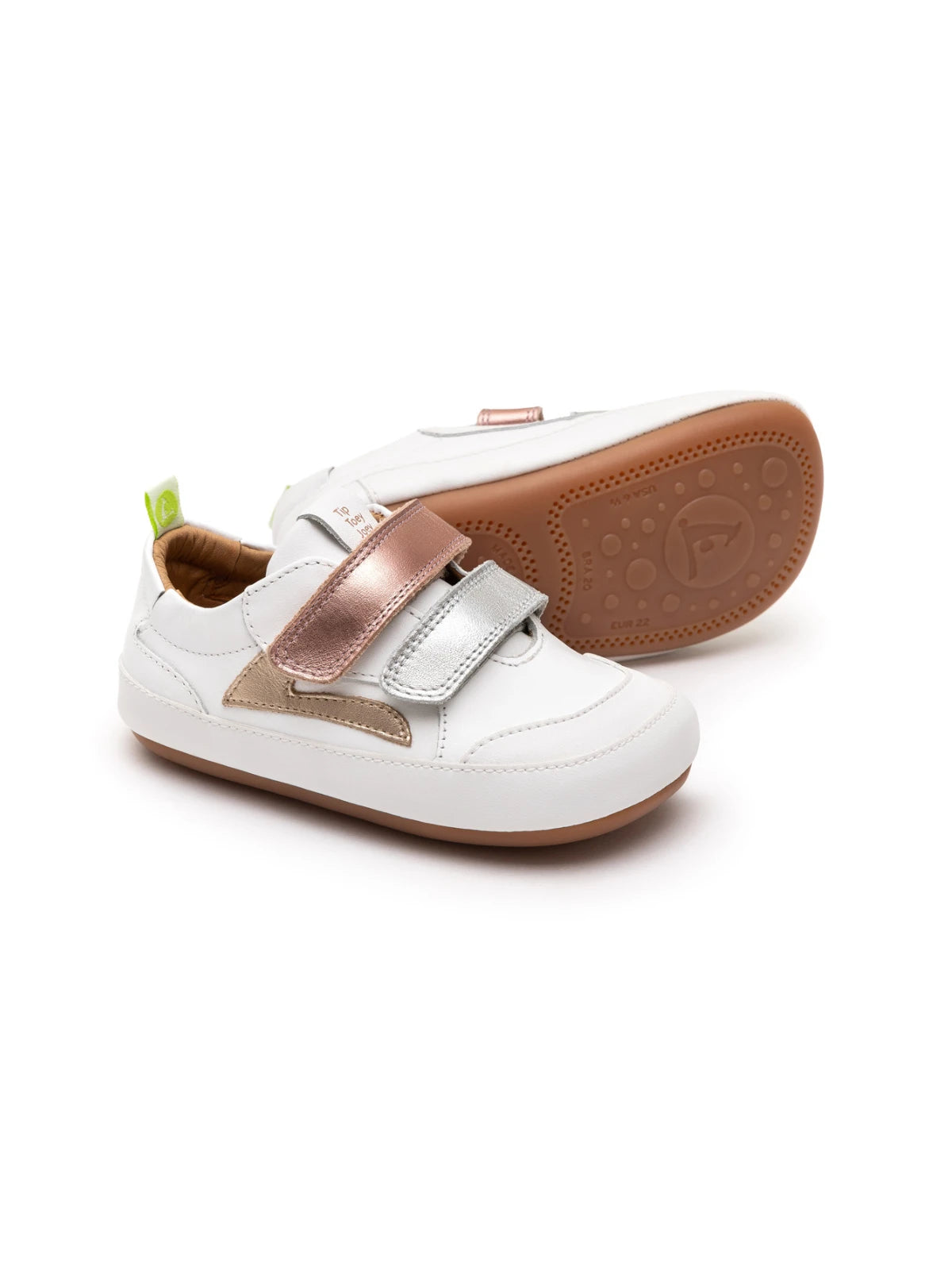 White leather baby sneakers with metallic sterling silver and rose gold accents and double velcro straps.