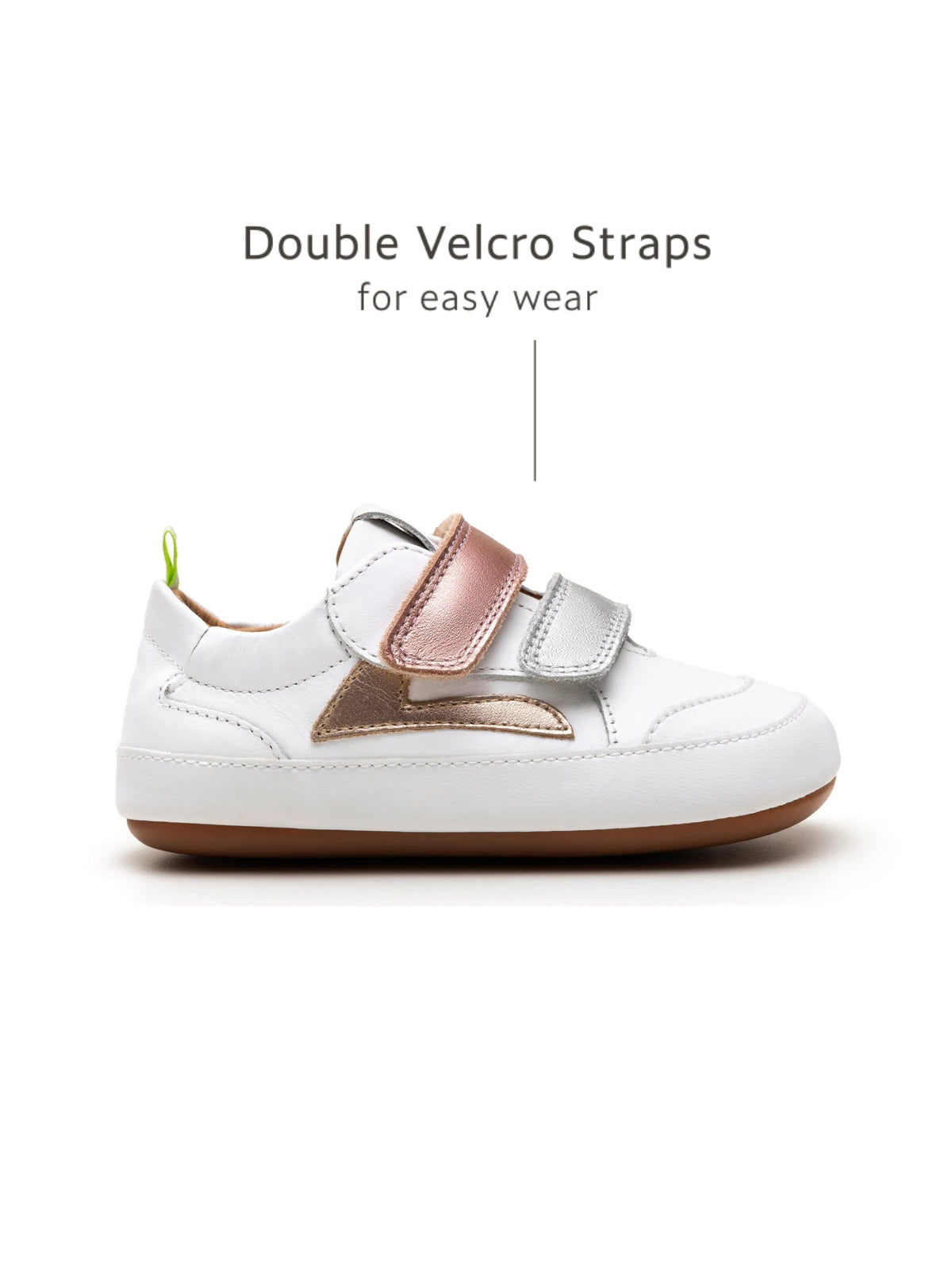 Side view of white and metallic baby sneakers highlighting the adjustable double velcro straps for a secure fit.