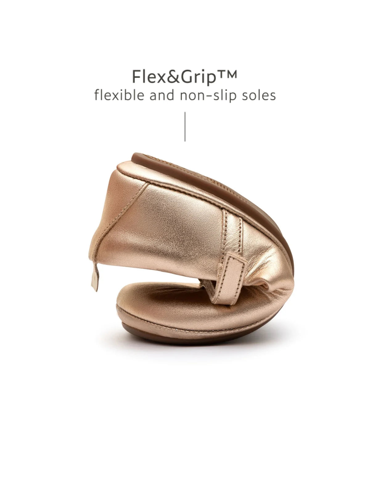 Demonstrating the flexible FlexiGrip sole on the metallic salmon kids shoe, designed for natural movement and play.