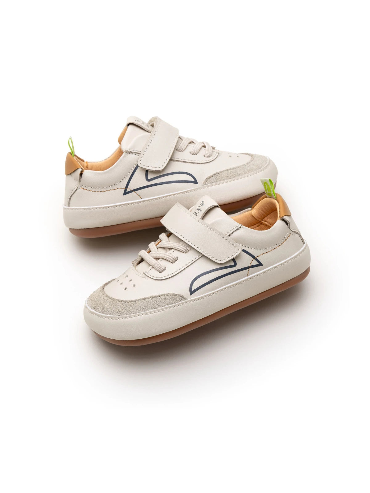 Angled view of a baby Outline sneaker showing the mixed leather and suede panels and secure velcro closure.
