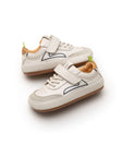 Angled view of a baby Outline sneaker showing the mixed leather and suede panels and secure velcro closure.
