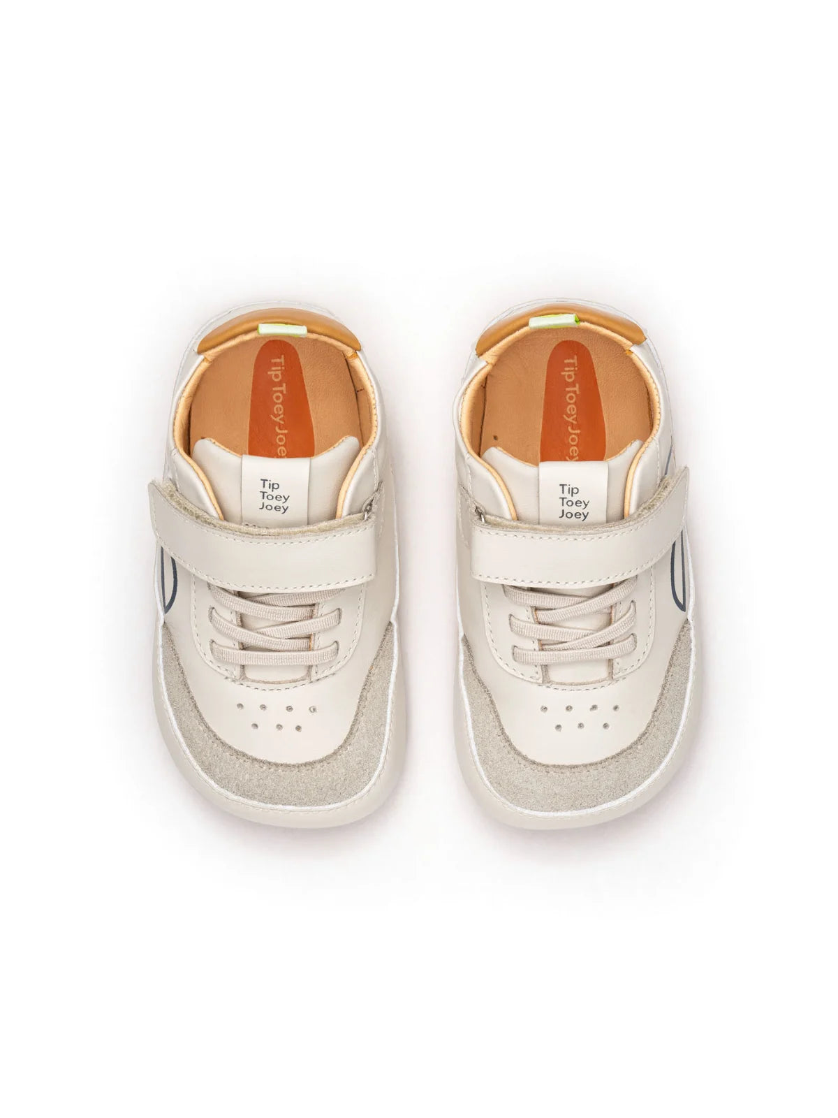 Overhead view of tapioca and ivory baby sneakers highlighting the wide toe box for natural foot growth.
