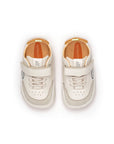 Overhead view of tapioca and ivory baby sneakers highlighting the wide toe box for natural foot growth.