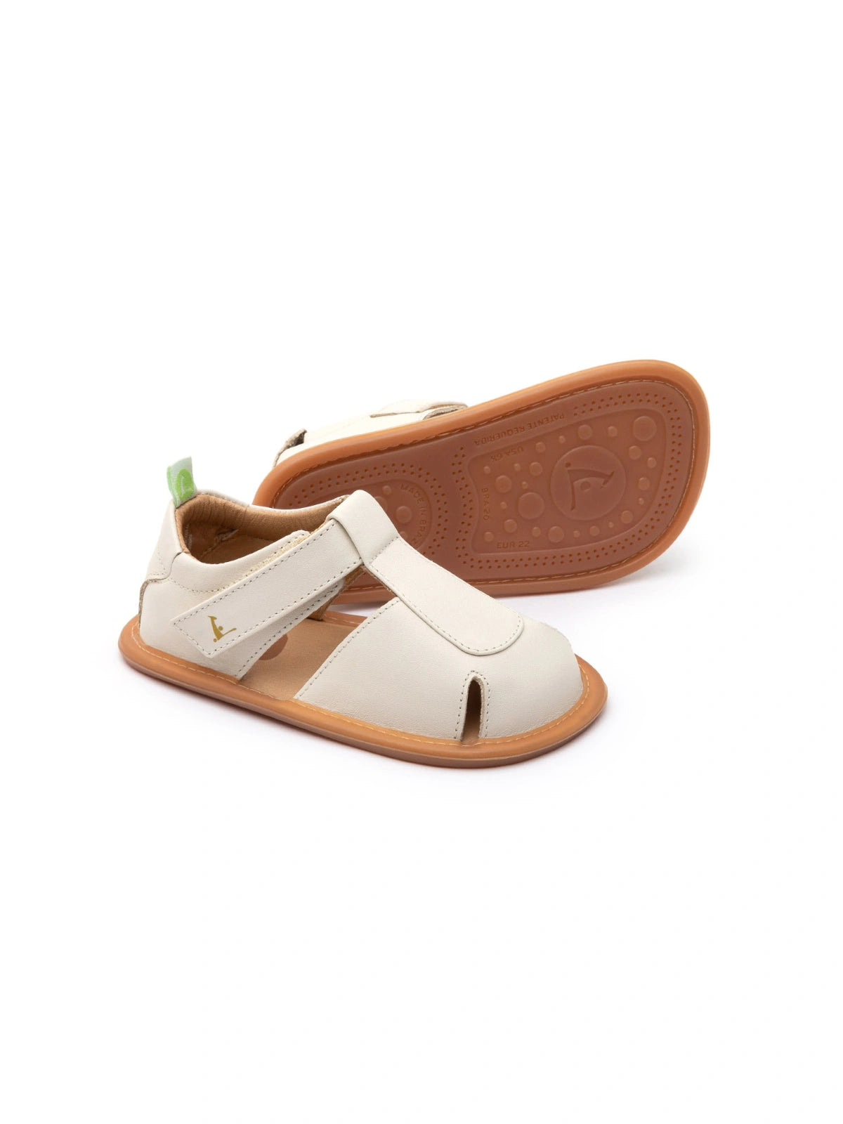 Tapioca off-white leather baby sandals with a closed toe, adjustable strap, and flexible gum rubber sole.