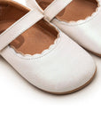 Close-up of the delicate scalloped edge and premium white dream leather finish on the baby Roundy shoe.