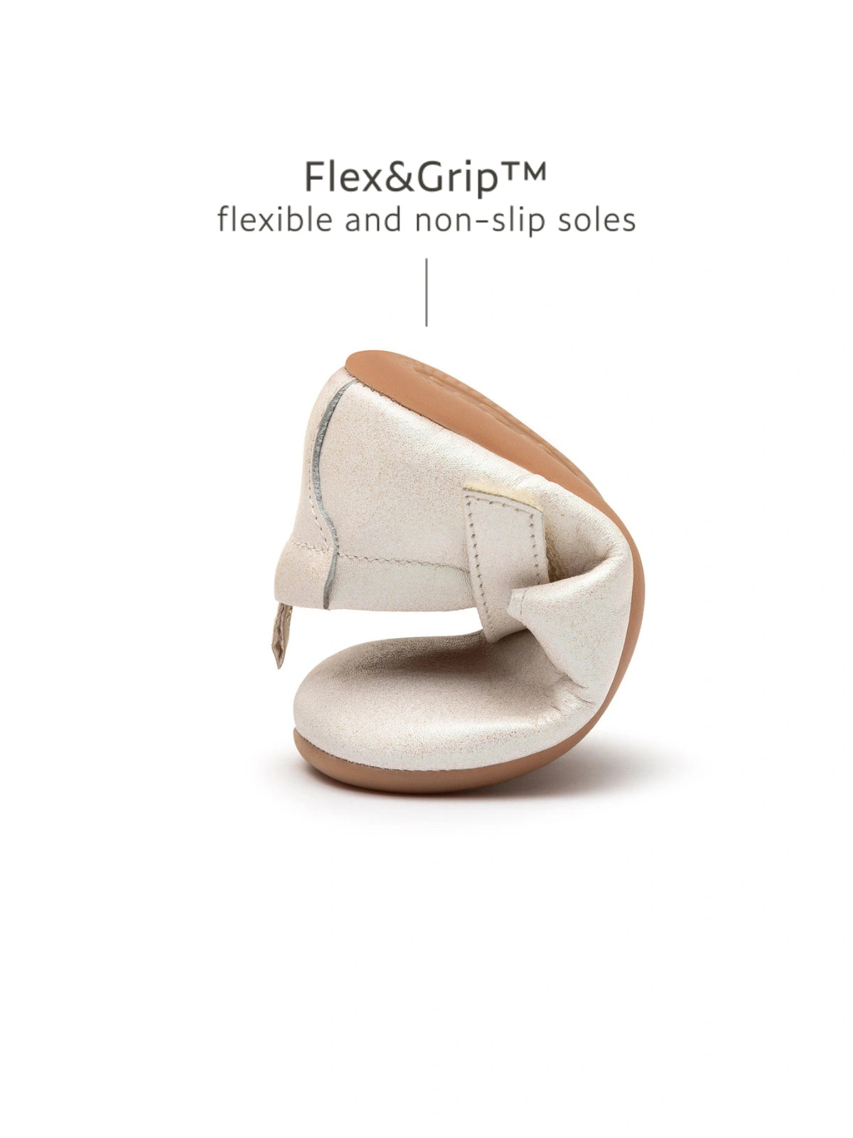 Demonstrating the flexible FlexiGrip rubber sole on the white dream baby shoe for natural barefoot movement.