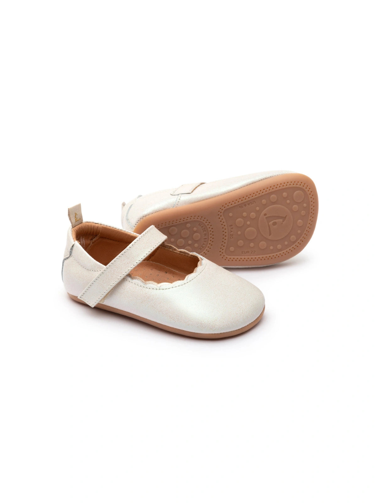 Soft white dream leather baby shoes with a scalloped edge and metallic champagne gold strap detail.