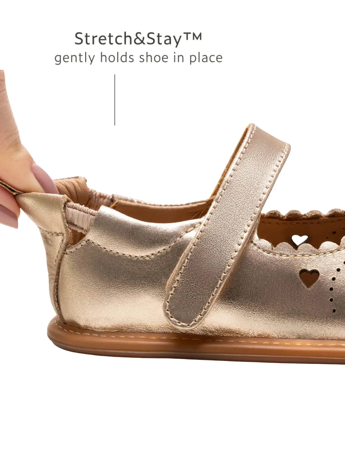 Close-up of the Stretch & Stay elastic heel on the metallic salmon baby shoe for a secure and comfortable fit.