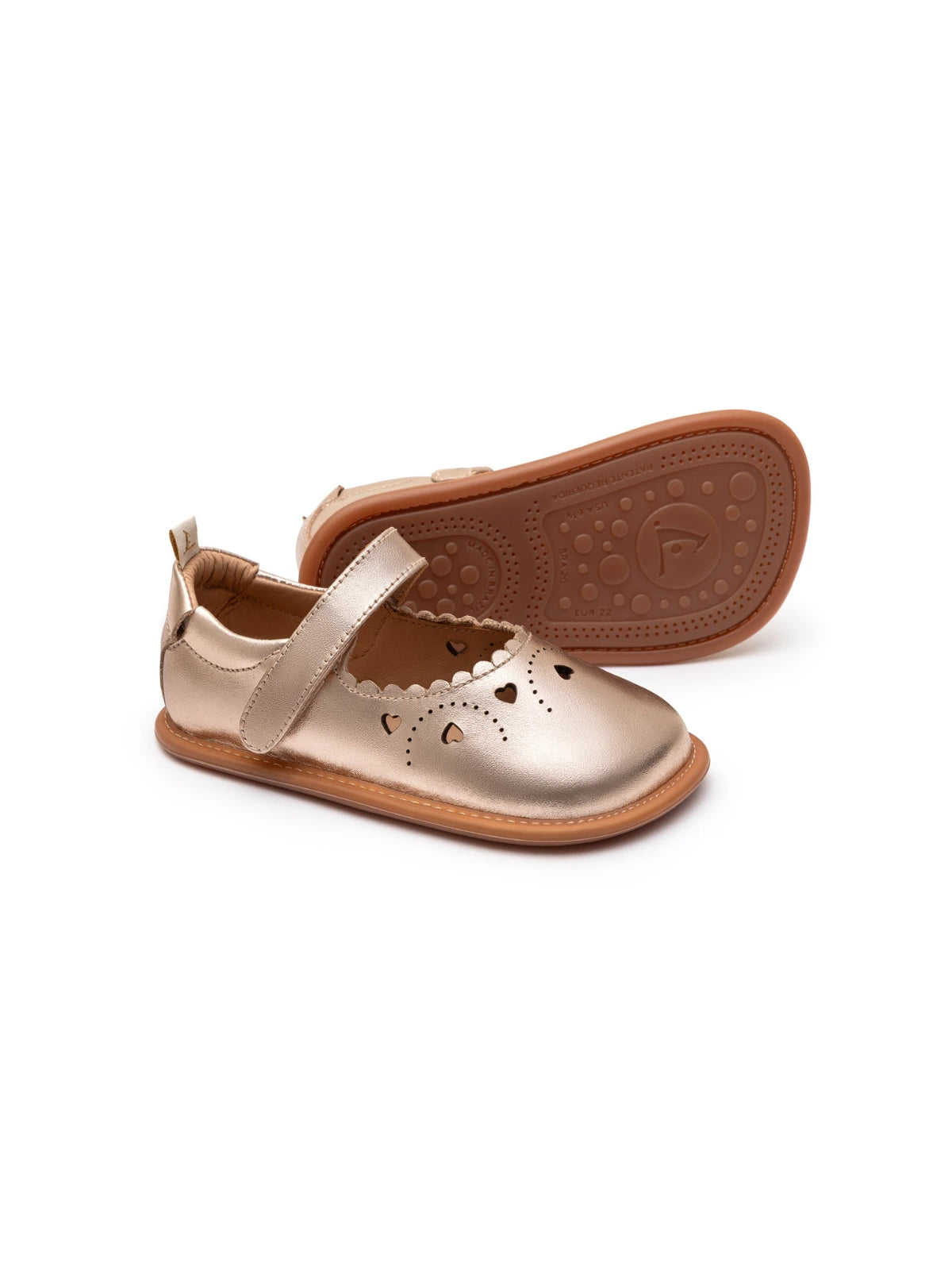 Metallic salmon leather baby Mary Janes featuring decorative heart cut-outs and a flexible rubber sole.