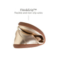 Demonstrating the flexible Flex & Grip sole on the kids metallic salmon Mary Jane for natural movement.