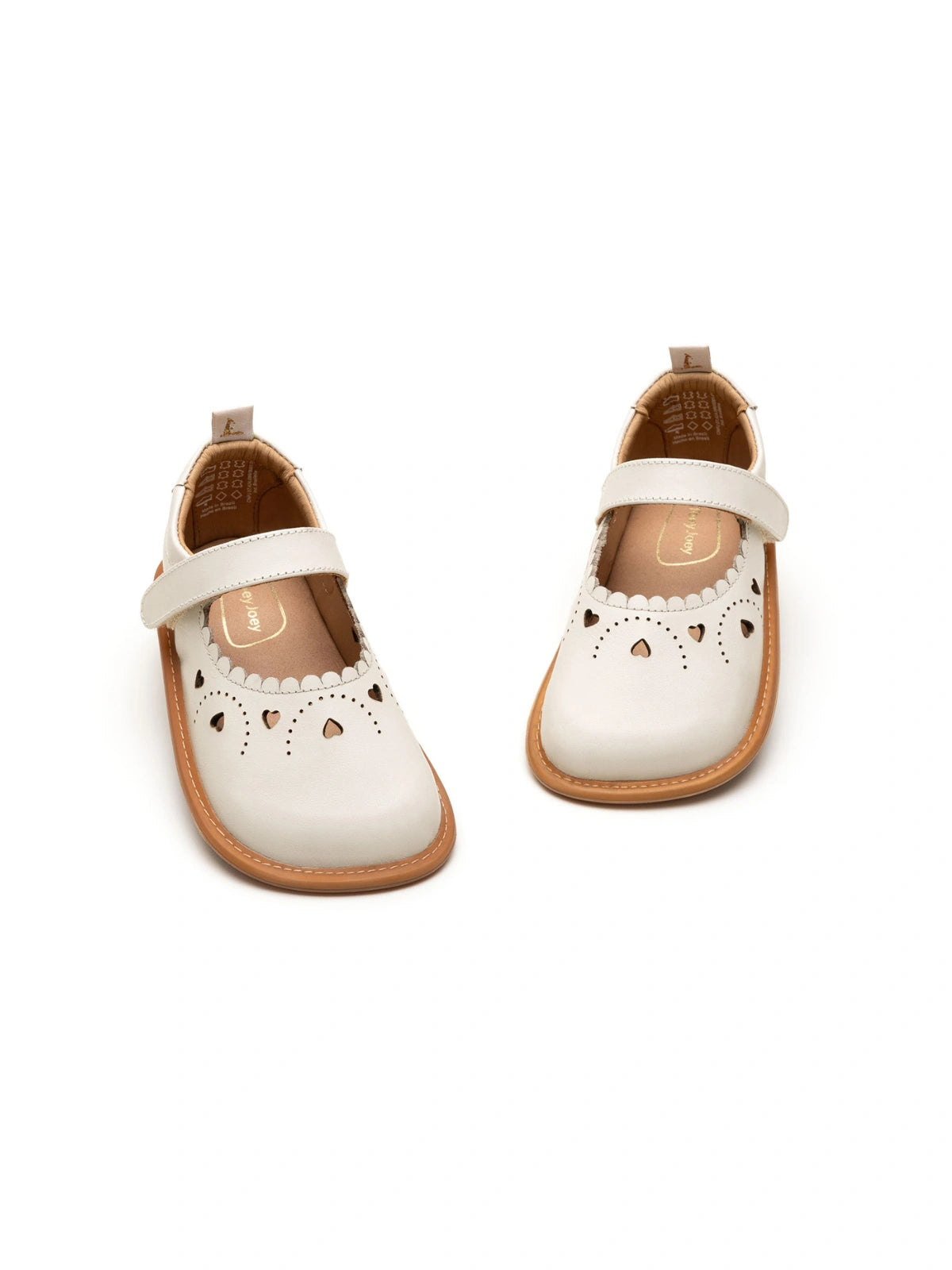 Angled view of Tapioca baby shoes showing the soft leather finish and decorative heart toe detail.