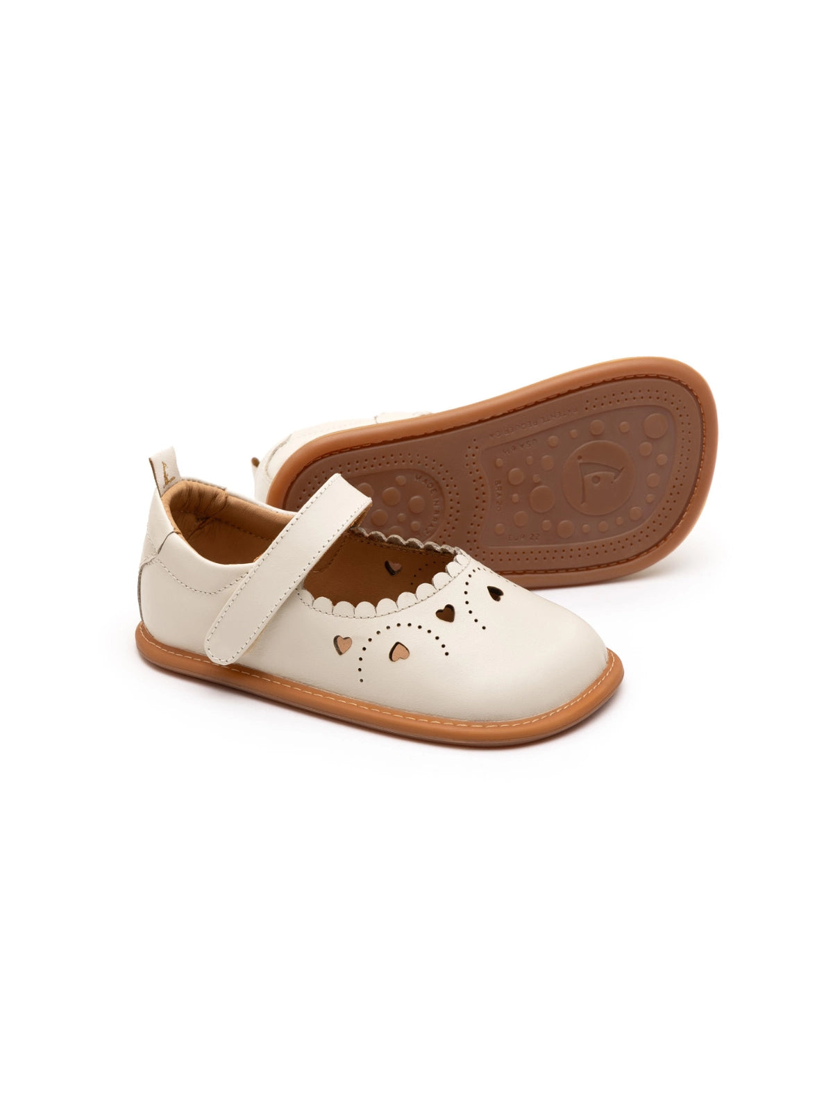Tapioca off-white leather baby Mary Janes with heart cut-outs and a flexible rubber sole.