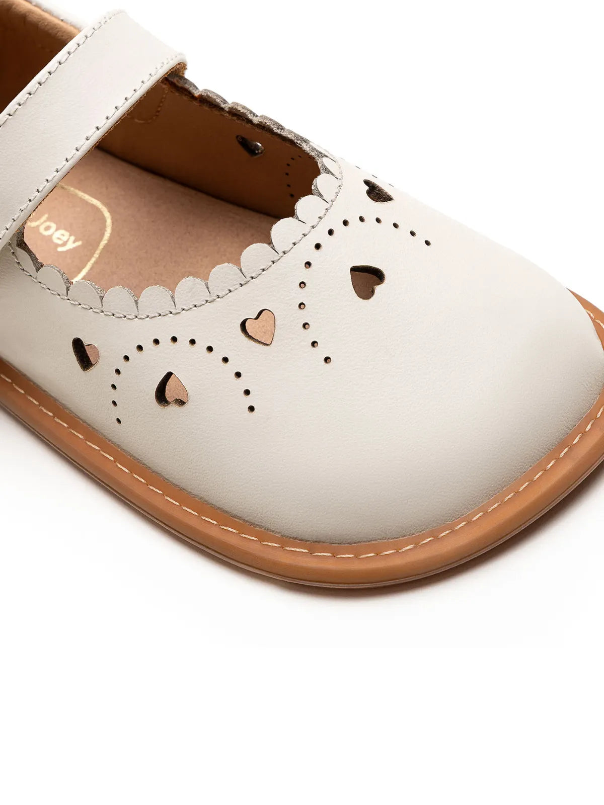 Close-up of the intricate heart-shaped laser cut-outs on the Tapioca leather baby shoe toe box.