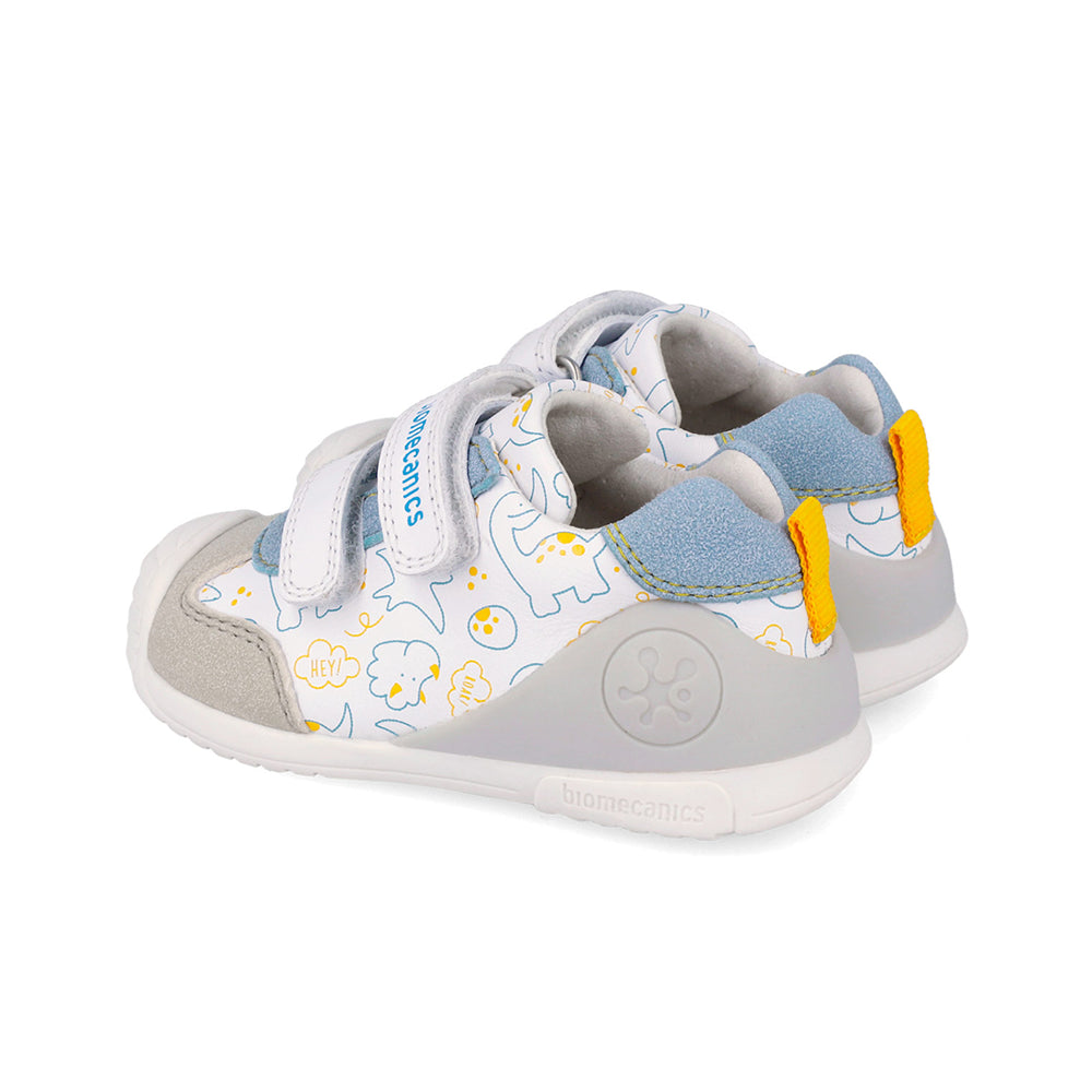 Children's shoe with dinosaur design and grey and blue accent on a white background