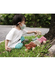 Plan Toys - Push Along Bunny Pink (Playing Side View)
